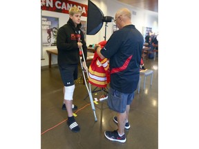 Calgary Flames defenceman Juuso Välimäki (L) chats with team photographer Brad Watson after having his portrait done during fitness testing day for the NHL team held at WInsport on Thursday, September 12, 2019. The Finnish defenceman injured his knee recently and will most likely miss the season. Photo by Jim Wells/Postmedia.