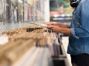 Man browsing vinyl album in a record store.