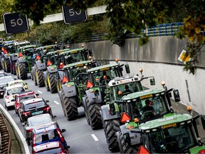 Farmers drive their tractors in a line in The Hague on October 16, 2019 during a protest against the nitrogen policy rules.