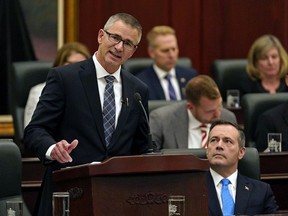 Alberta Finance Minister Travis Toews, left, delivers his budget speech as Alberta Premier Jason Kenney listens at the Alberta legislature in Edmonton on Thursday October 24, 2019.