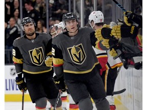 Golden Knights William Carrier and Tomas Nosek celebrate with teammates on the bench after Carrier assisted Nosek on a first-period goal against the Calgary Flames during their game at T-Mobile Arena on Saturday night in Las Vegas.