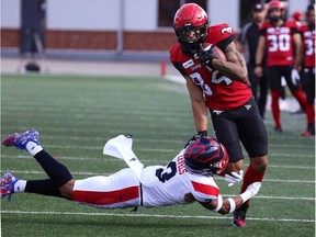 The Calgary Stampeders' Reggie Begelton runs the ball and is grabbed by the Montreal Alouettes' Patrick Levels during CFL action at McMahon Stadium in Calgary on Saturday August 17, 2019. Gavin Young/Postmedia