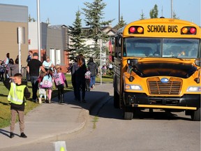 AMA School Safety patrollers guide their classmates and parents across the crosswalks near Chaparral School on the first day of classes, Tuesday September 3, 2019.