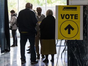 Voters enter the advance polling station at Ottawa City hall on Friday.