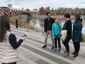 Climate activist Greta Thunberg speaks with city of Calgary staff who were out on a site tour near the Peace Bridge on Wednesday.