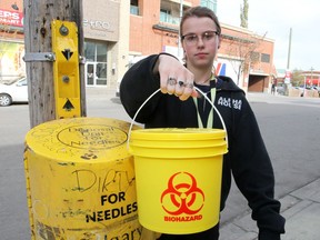 Jacqueline Jerram, an outreach worker with Alpha House, is seen holding a bio hazard bucket as the Alpha House team has initiated proactive needle patrols downtown.