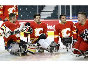 Ryan Straschnitzki was presented a jersey as hockey players from the non-profit PX3 AMP Sledge Hockey Academy have been endorsed by the Calgary Flames as its affiliate sledge hockey team at the upcoming 2019 USA Hockey Sled Classic presented by the NHL in St. Louis from Nov. 21 – Nov. 24, 2019 at the Scotiabank Saddledome in Calgary on Wednesday, October 30, 2019. Darren Makowichuk/Postmedia