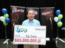 Lottery winner Tai Trinh is presented with a giant check at a press conference in Calgary on Thursday, October 31, 2019, where he was introduced as a $65 million LOTTO MAX winner in the October 4 drawing.  His win is the largest in Alberta history and tied for the largest win in any part of Canada.  Jim Wells/Postmedia