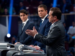 Canada's Prime Minister and Liberal leader Justin Trudeau (L), Conservative leader Andrew Scheer (C) and Bloc Quebecois leader Yves-Francois Blanchet take part in the the Federal leaders French language debate in Gatineau, Que. on Thursday, October 10, 2019.