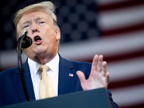 U.S. President Donald Trump gestures as he speaks during a "Keep America Great" rally at Sudduth Coliseum at the Lake Charles Civic Center in Lake Charles, Louisiana, on October 11, 2019. (Photo by SAUL LOEB / AFP)