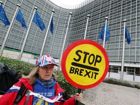 A woman holds a sign as she attends a protest against Brexit outside the EU Commission headquarters in Brussels, Belgium October 9, 2019. REUTERS/Yves Herman ORG XMIT: GDN404