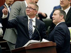 Alberta Finance Minister Travis Toews and Premier Jason Kenney after Toews delivered his budget speech at the Alberta Legislature in Edmonton on Oct. 24, 2019.