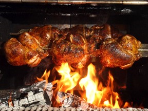 Chicken cooking inside of the rotary wood fired oven grill at NOtaBLE restaurant.