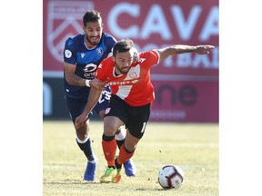 Edmonton FC Ajay Khabra (L) and Cavalry FC Sergo Camargo competed for a loose ball in midfield during CPL soccer action between FC Edmonton and Cavalry FC at ATCO Field at Spruce Meadows in Calgary on Saturday, October 19, 2019. Jim Wells/Postmedia