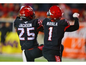 The Calgary Stampeders' Hergy Mayala celebrates with teammate Don Jackson after his touchdown against the Saskatchewan Roughriders during CFL football in Calgary on Friday. Photo by Al Charest/Postmedia.
