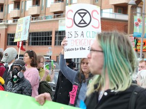 Climate activists are seen blocking traffic along Memorial Drive in Kensington as they join other Canadians in a global climate strike led by "Extinction Rebellion" on Monday, October 7, 2019.