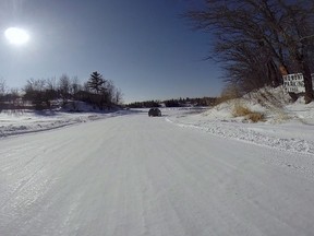 A car enters a winter road which crosses Shoal Lake to Shoal Lake 40 first nation on Wednesday, February 25, 2015. Across Canada, there are at least 10,000 kilometres of roads that depend on freezing temperatures. Most are in Ontario, but they exist in four provinces and two territories.