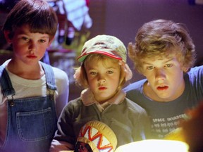 This 1982 file photo originally released by Universal Pictures shows actors, from left, Henry Thomas, Drew Barrymore and Robert MacNaughton in a scene from the film, "E.T.: The Extra- Terrestrial." THE CANADIAN PRESS/AP Photo/Universal Pictures-Amblin Entetainment, Bruce McBroom