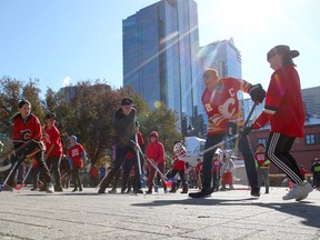 Current and past Grade 6 students participate in a street hockey game to celebrate the Flames Foundation's $1-million donation to YMCA Grade 6 program in Eau Claire on Friday, Oct. 11, 2019.