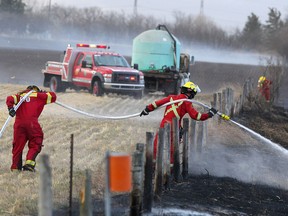 A grass fire is seen burning in a field east of Airdrie along Highway 567 on Friday, Oct. 25, 2019.