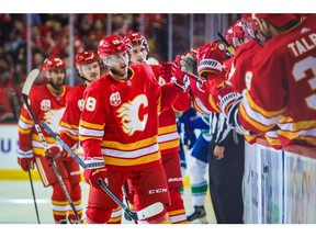 Oct 5, 2019; Calgary, Alberta, CAN; Calgary Flames center Elias Lindholm (28) celebrates his goal with teammates against the Vancouver Canucks during the first period at Scotiabank Saddledome. Mandatory Credit: Sergei Belski-USA TODAY Sports ORG XMIT: USATSI-405022