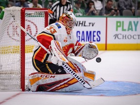 Calgary Flames goaltender David Rittich (33) makes a save on a Dallas Stars shot during the overtime period at the American Airlines Center