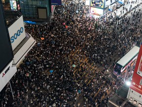 Pro-democracy protesters march on a street as they take part in a rally in Causeway Bay district on October 4, 2019 in Hong Kong.