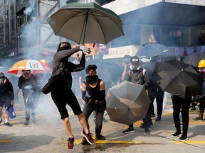 An anti-government demonstrator throws back a tear gas canister during a protest march in Hong Kong, China, October 20, 2019. REUTERS/Kim Kyung-Hoon     TPX IMAGES OF THE DAY ORG XMIT: GDN113