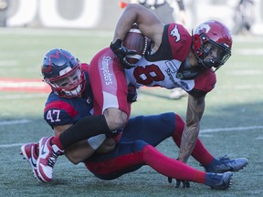 Montreal Alouettes' DJ Lalama (47) brings down Calgary Stampeders' Reggie Begelton during first half CFL football action in Montreal, Saturday, October 5, 2019. THE CANADIAN PRESS/Graham Hughes