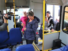 Local family Roam (left to right), Laurainne, Cali and Jaclyn Laliberte board Cochrane's inaugural transit ride on October 7 en route to an infant music class downtown. Patrick Gibson/Cochrane Times
