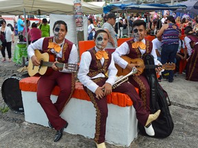 An image of a young mariachi band with their faces painted for the Day of the Dead grand parade in Puerto Vallarta, Mexico.