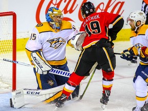 Nashville Predators goalie Pekka Rinne stops Matthew Tkachuk last season at the Saddledome. The Flames travel to Nashville on Thursday.