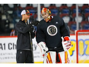 Calgary Flames David Rittich and goalie coach Jordan Sigalet prepare for the season opener against the Colorado Avalanche. Photo by Al Charest/Postmedia.