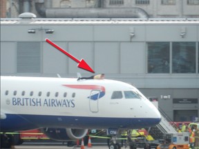 A man climbs atop a British Airways jet, delaying the flight at London City Airport on Oct. 10, 2019.