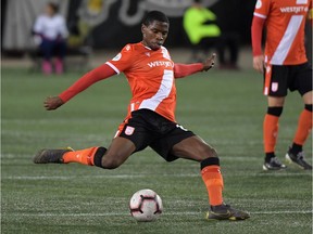 Cavalry FC midfielder Elijah Adekugbe (16) shoots the ball against Forge FC in the second half of a Canadian Premier League soccer match at Tim Hortons Field. Photo by Dan Hamilton/USA TODAY Sports.