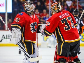 Flames goaltender David Rittich, right, is replaced by Cam Talbot during a pre-season game against the Vancouver Canucks at Scotiabank Saddledome on Sept. 16, 2019.