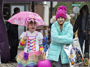 Young trick-or-treaters brave the not-so-torrential rain in Brantford, Ont., in 2018.
