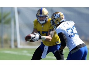Quarterback Chris Streveler hands off to running back Andrew Harris during Winnipeg Blue Bombers practice on the University of Manitoba campus in Winnipeg earlier this season. File photo by Kevin King/Postmedia.