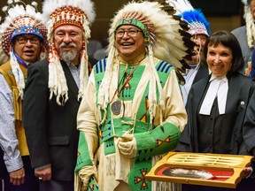 Chiniki Chief Aaron Young, left, Piikani First Nation Chief Stanley Grier, Traditional knowledge keeper Leonard Bastien, and Justice Marina Paperny of the Alberta Court of Appeal pose for a photo at the Alberta Courts eagle feather ceremony. Witnesses will now be allowed to swear oaths upon the eagle feather, which is a sign of respect for Indigenous cultures and a step towards reconciliation.