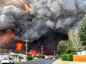 This handout picture taken and received from Kelly-ann Oosterbeek on November 8, 2019 shows flames from an out of control bushfire seen from a nearby residential area in Harrington, some 335 kilometers northeast of Sydney. - Australian firefighters warned they were in "uncharted territory" as they struggled to contain dozens of out-of-control bushfires across the east of the country on November 8. (Photo by Kelly-ann Oosterbeek / Kelly-ann Oosterbeek / AFP)