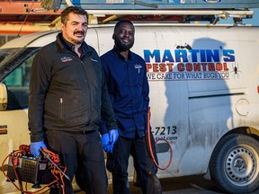 William Martin, left, and Abe Mawoyo, from Martin's Pest Control pose for a photo in Airdrie on Wednesday, Nov. 13, 2019.