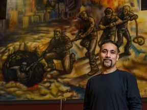 Robby Sidhu, a former client at Fresh Start Recovery Centre and the president of the Fresh Start Alumni Association, poses for a photo with a mural by Vince Wish-Art one of the centreÕs alumni on Monday, November 18, 2019. Azin Ghaffari/Postmedia Calgary