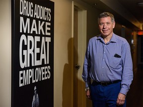 Wayne Steer, Fresh Start Recovery Centre director of fund development, poses for a photo on Monday, November 18, 2019 with a poster that was used in community in order to bring awareness about the Centre upon its opening. Azin Ghaffari/Postmedia Calgary