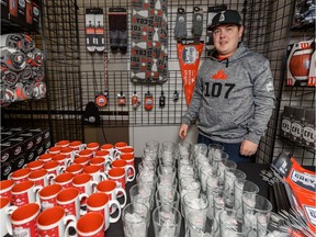 Riley Anderson, retail operation manager at a Grey Cup store, poses for a photo with some of the merchandise at the shop on Wednesday, November 20, 2019. Azin Ghaffari/Postmedia Calgary
