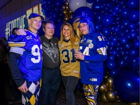 Winnipeg Blue Bombers fans Jay Diamond, left, Steve Bollinger and Daisy MacCallum, both from California, and Martin Shaff from Winnipeg pose for a photo at BMO Centre on Friday, November 22, 2019.