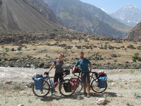 Trevor and Emily Gair with their bikes near the Panj River, which separates Tajikistan and Afghanistan. They cycled next to this river for 500 kilometres.