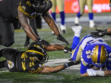 Winnipeg Blue Bombers Andrew Harris gets tackled by Hamilton Tiger-Cats Delvin Breaux during the Grey Cup CFL championship football game on Sunday, November 24, 2019. Azin Ghaffari/Postmedia Calgary