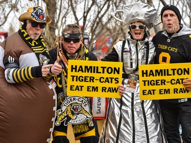 Hamilton Tiger-Cats fans Guy Gerard, right, Sherree Bashak, Dave Armstrong, and Steve Bashak, pose for a photo as they head to McMahon Stadium for Grey Cup CFL championship football game on Sunday, November 24, 2019. Azin Ghaffari/Postmedia Calgary