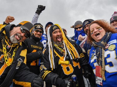 A group of Hamilton Tiger-Cats and Winnipeg Blue Bombers fans pose for a photo as they head to McMahon Stadium for Grey Cup CFL championship football game on Sunday, November 24, 2019. Azin Ghaffari/Postmedia Calgary