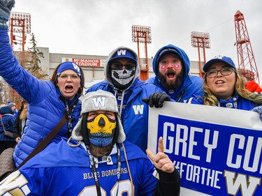 A group of Hamilton Tiger-Cats fans pose for a photo as fans head to McMahon Stadium for Grey Cup CFL championship football game on Sunday, November 24, 2019. Azin Ghaffari/Postmedia Calgary